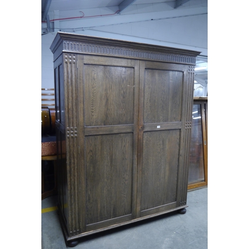 2456 - A substantial oak two door wardrobe      (E) £40-60