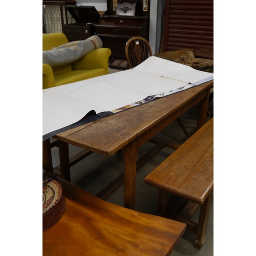 2450 - A country oak low serving table, plank top, faceted supports, 147cm long