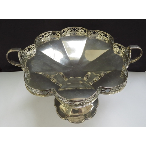 6362 - A silver tazza, the lobed dish with pierced galleried border, two handles. raised on a tapering colu... 