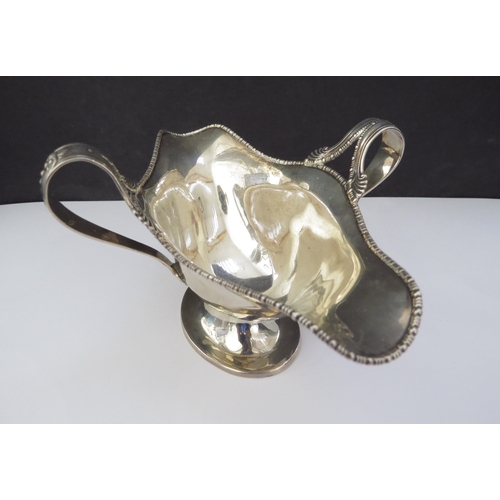 6459 - A Barker Bros silver twin handled sauce boat, beaded edge double pourer, Chester 1907, base slightly... 