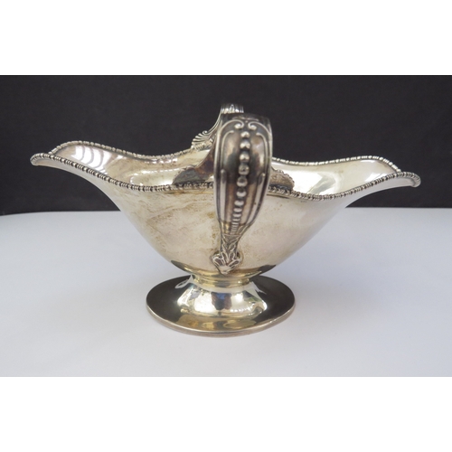 6459 - A Barker Bros silver twin handled sauce boat, beaded edge double pourer, Chester 1907, base slightly... 