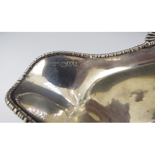 6459 - A Barker Bros silver twin handled sauce boat, beaded edge double pourer, Chester 1907, base slightly... 