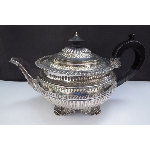 6357 - A William Fountain silver teapot embossed foliate borders, reeded half body, raised on four scroll c... 