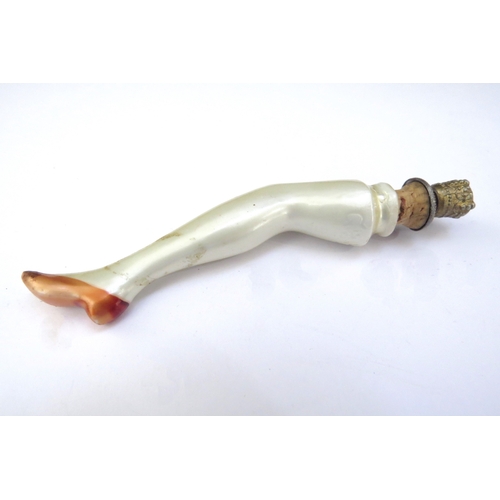 6441 - A 1920's Ges Gesch German scent bottle as a female leg, milk lustre with an orange shoe, gilt crown ... 