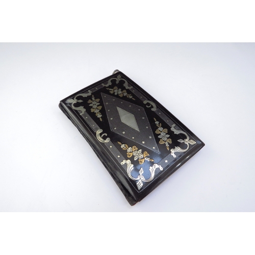 6440 - A 19th Century aide memoire, black lacquered with silver and gold inlay of scrolls and floral swags,... 