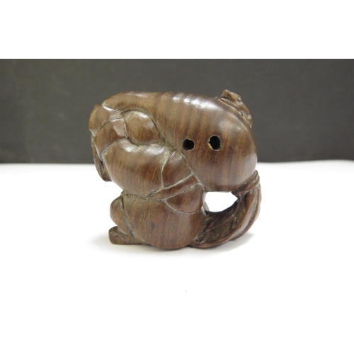 6410 - A Meiji period (1868-1912) Japanese wood Netsuke figure carrying a large root vegetable with mouse t... 