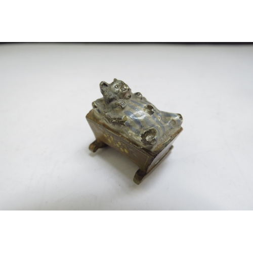 6387 - Four cold painted bronze miniature figures including chick, cat, frog and dog embracing