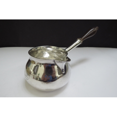 6442 - A George II silver brandy warmer of squat form, turned wooden handle, engraved with a crest for the ... 