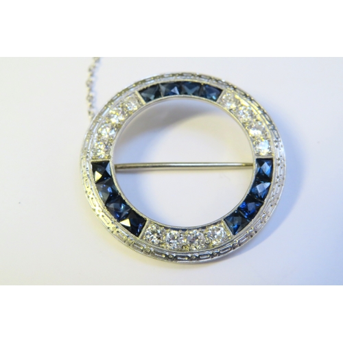 6400 - An Art Deco style circular brooch, each third set with four brilliant cut diamonds and four square f... 