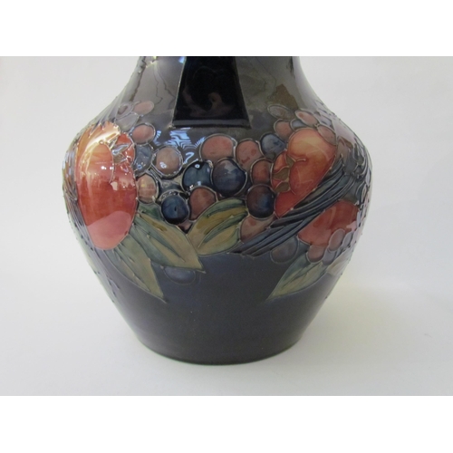 6276 - A Moorcroft Finch and Berries on blue large twin handled vase, 34cm tall