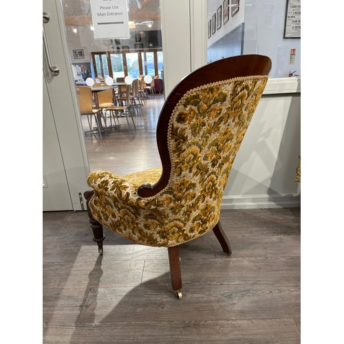 6007 - A Victorian spoon-back armchair with damask upholstery, edging loose