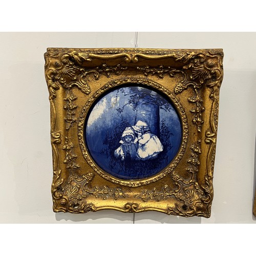 6014 - Two gilt framed blue and white pictorial porcelain plaques of circular form, 17cm diameter