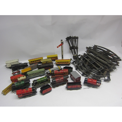 8498 - A collection of assorted playworn 0 gauge model railway locomotives, rolling stock and accessories i... 