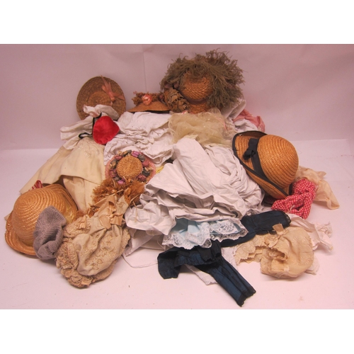 8309 - A large collection of dolls clothing including linen dresses, straw hats etc