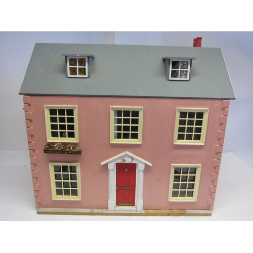 8267 - A front opening two storey dolls house with attic rooms above, containing assorted furniture and acc... 