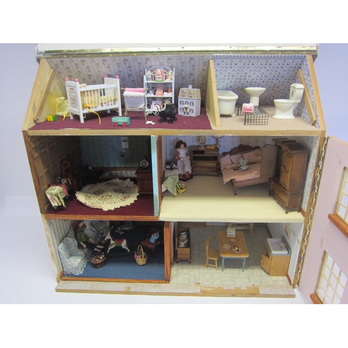 8267 - A front opening two storey dolls house with attic rooms above, containing assorted furniture and acc... 