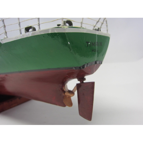 8420 - A wood and fibre glass kit built model ship 'Timrix', finished in green and red with brass propellor... 