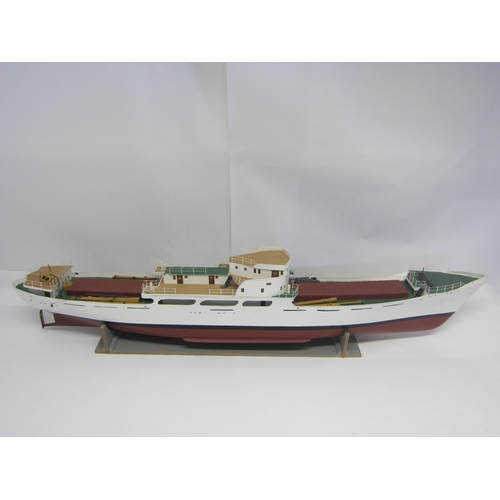 8422 - A wood and fibre glass kit built model ship finished in red, green and white, 109cm long, on stand  ... 