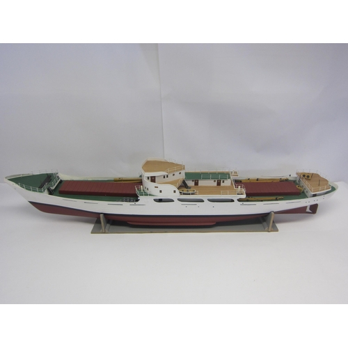 8422 - A wood and fibre glass kit built model ship finished in red, green and white, 109cm long, on stand  ... 