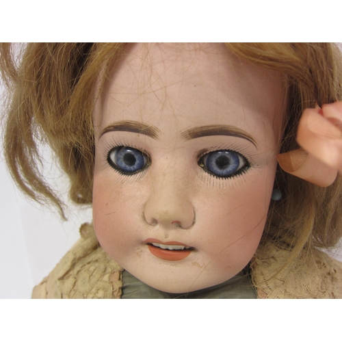 8314 - An early 20th Century French bisque head girl doll with blonde wig, striated blue glass fixed eyes, ... 