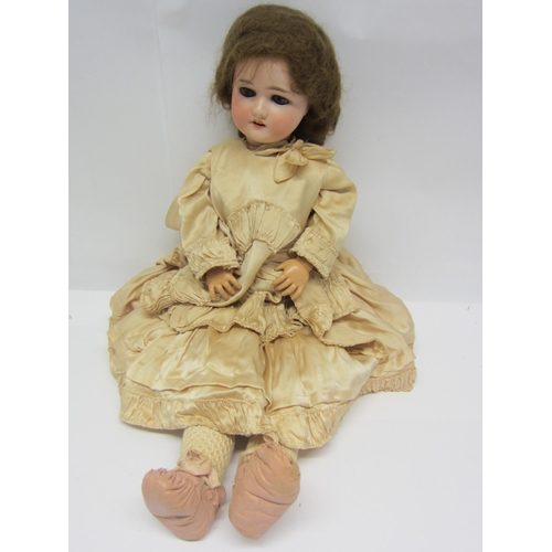 8315 - An early 20th Century Schoneau & Hoffmeister bisque head girl doll with brown wig, striated blue gla... 