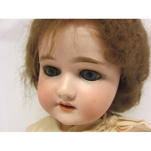 8315 - An early 20th Century Schoneau & Hoffmeister bisque head girl doll with brown wig, striated blue gla... 