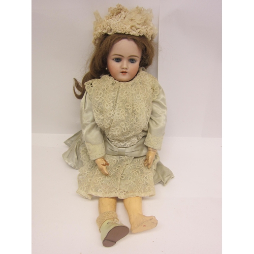 8328 - An early 20th Century German bisque head doll with mousey brown wig, striated blue glass sleepy eyes... 