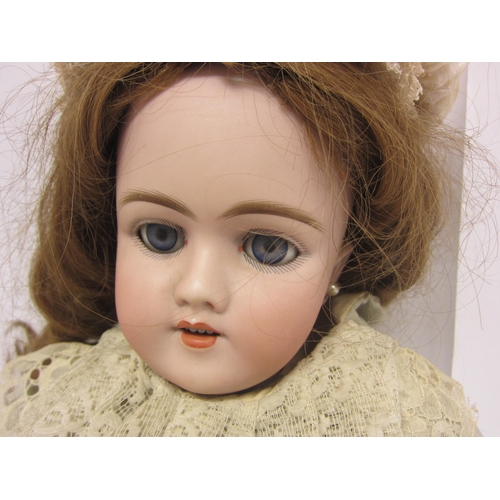 8328 - An early 20th Century German bisque head doll with mousey brown wig, striated blue glass sleepy eyes... 