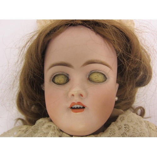 8328 - An early 20th Century German bisque head doll with mousey brown wig, striated blue glass sleepy eyes... 