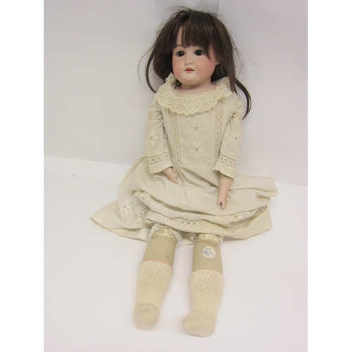 8330 - An early 20th Century Armand Marseille bisque head girl doll with brown wig, brown glass sleepy eyes... 