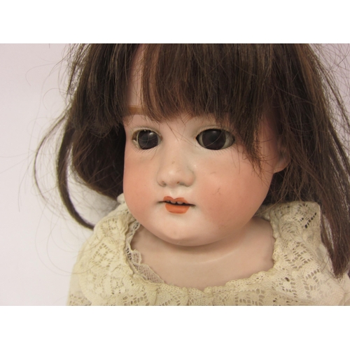 8330 - An early 20th Century Armand Marseille bisque head girl doll with brown wig, brown glass sleepy eyes... 