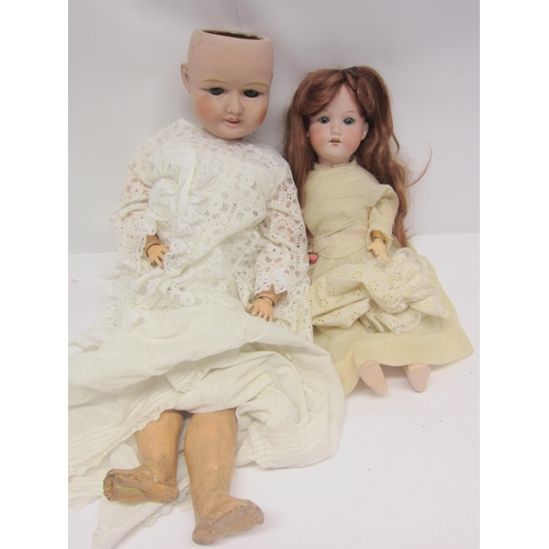 8321 - Two early 20th Century bisque head dolls on articulated composition bodies, to include Armand Marsei... 