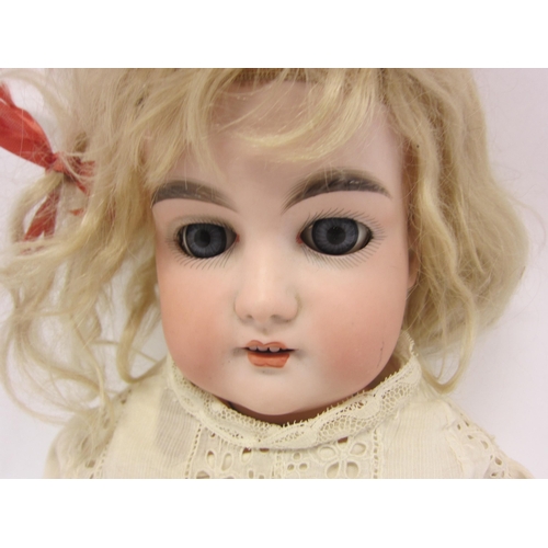 8325 - An early 20th Century Armand Marseille bisque head girl doll with blonde wig, striated blue glass sl... 