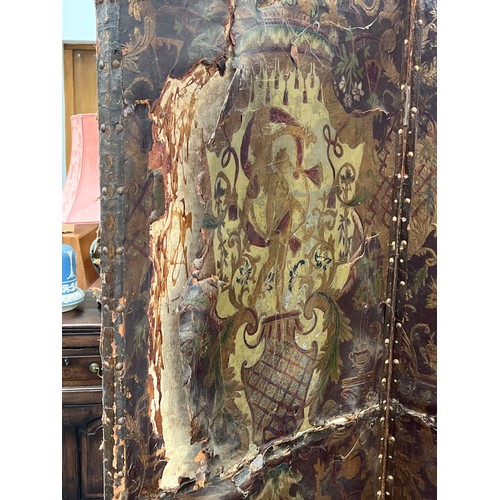 6040 - A highly decorative late 19th century leather four-fold room screen, each panel hand gilded (damage ... 