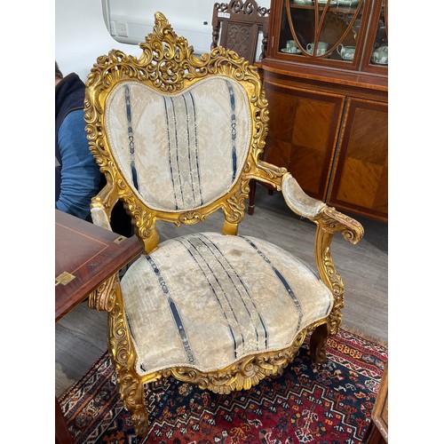 6044 - An early 20th Century French giltwood three piece suite with silk upholstery, some gilding is distre... 