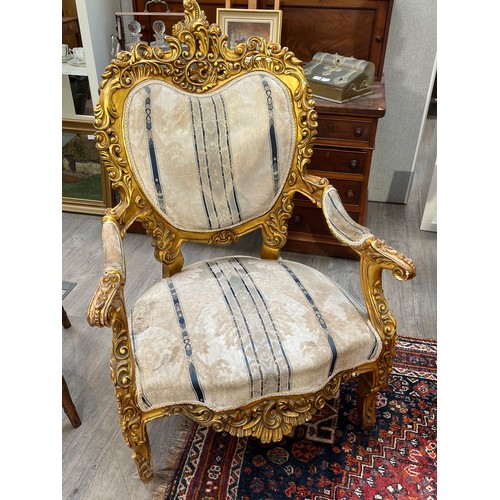 6044 - An early 20th Century French giltwood three piece suite with silk upholstery, some gilding is distre... 