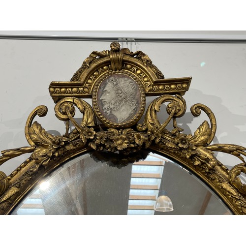 6062 - A late 18th / early 19th Century gilt gesso girandole wall mirror, the arched pediment with Romanesq... 