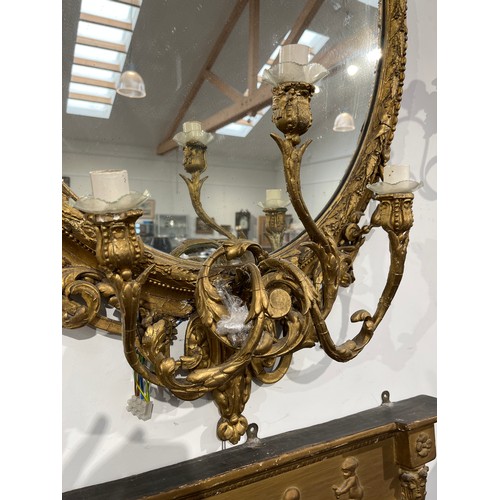 6062 - A late 18th / early 19th Century gilt gesso girandole wall mirror, the arched pediment with Romanesq... 