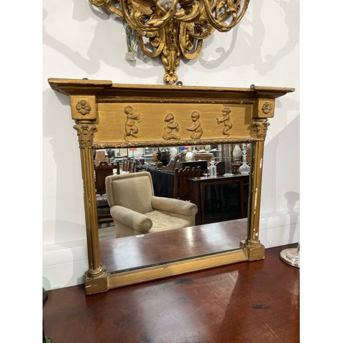 6063 - An early 19th Century ornate gilt gesso frame wall mirror with Corinthian reeded columns and child d... 