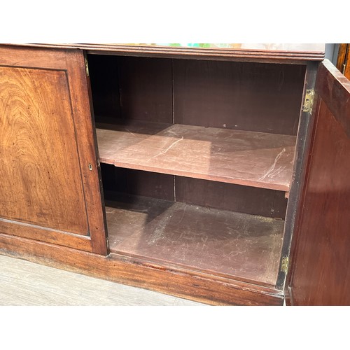 6066 - A 19th Century mahogany two door low housekeepers cupboard with reeded top, plinth base, 87cm, 125.5... 