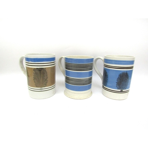 6057 - Three Quart Mocha ware tankards, two blue and one pale brown, one cracked, crazing to handle of one,... 