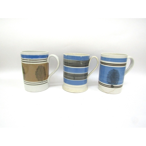 6057 - Three Quart Mocha ware tankards, two blue and one pale brown, one cracked, crazing to handle of one,... 