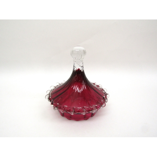 6119 - A cranberry glass lidded jar on pedestal base, one piece of prunt work damaged, 33cm tall