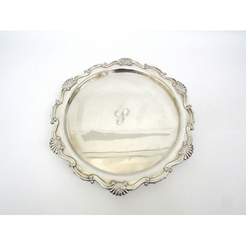 6155 - A Martin Hall and Co silver salver on claw and ball feet, Sheffield 1911, 32cm diameter, 800g