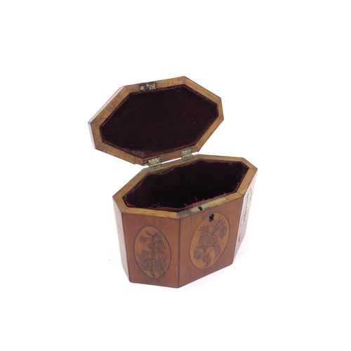 6168 - A 19th Century mixed wood octagonal tea caddy with velvet lined interior.  The top and three front p... 