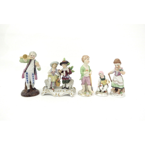 6318 - A Sitzendorf figural group and three Naples figures including child feeding chickens and couple with... 