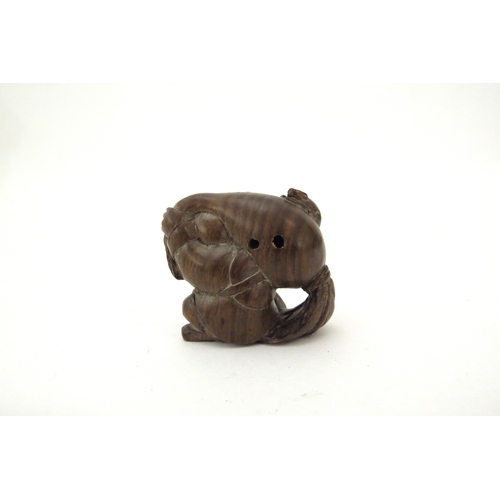 6410 - A Meiji period (1868-1912) Japanese wood Netsuke figure carrying a large root vegetable with mouse t... 