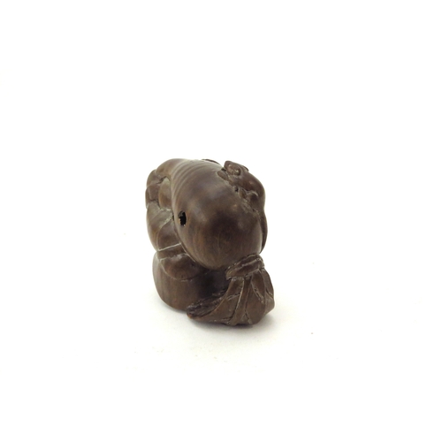 6410 - A Meiji period (1868-1912) Japanese wood Netsuke figure carrying a large root vegetable with mouse t... 