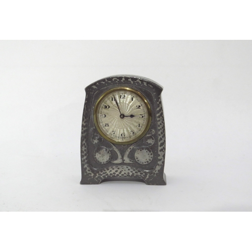 6444 - Liberty & Co Tudric pewter clock, No 01424, with Arabic numerals to the circular dial.  Hammered and... 