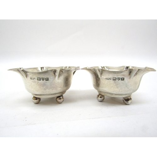 6472 - A silver mustard (no glass liner) pair of Victorian silver pepperettes and two Chester silver salts ... 